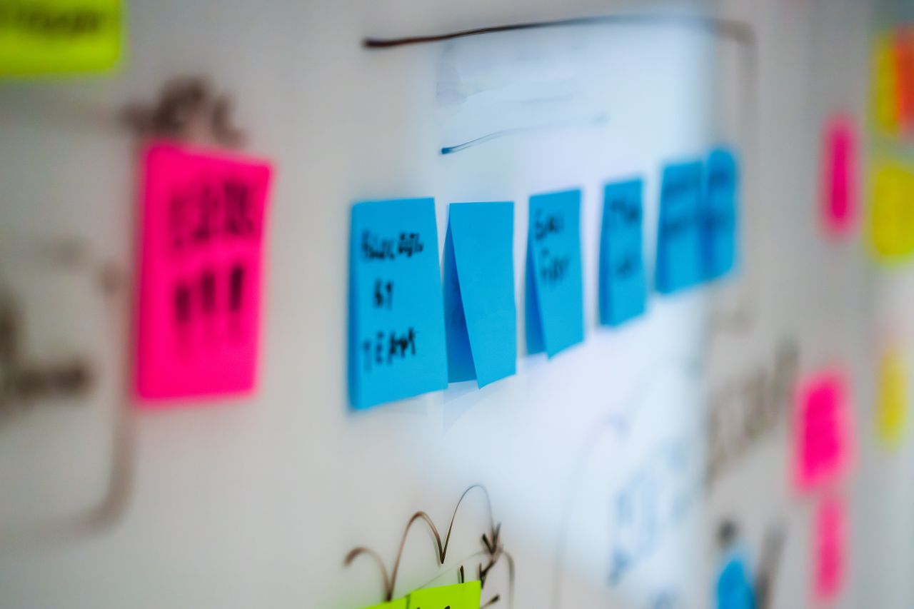 heros-img Sticky notes on a whiteboard during a creative brainstorming session in an office.